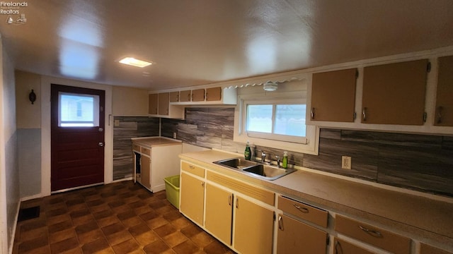 kitchen featuring sink and tasteful backsplash