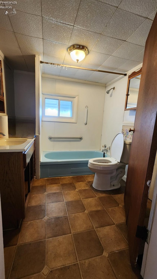 full bathroom with vanity, toilet, and washtub / shower combination