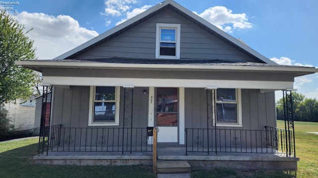 bungalow with a porch and a front yard