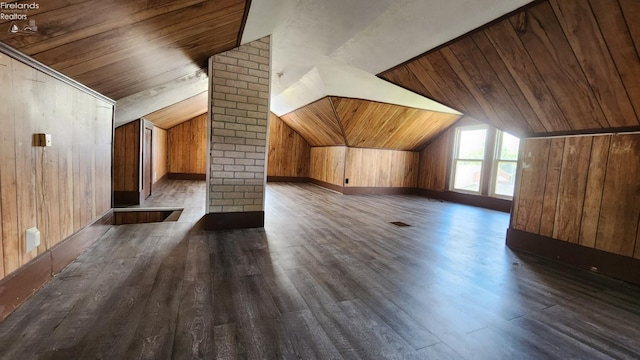 additional living space featuring vaulted ceiling, wood ceiling, dark wood-type flooring, and wood walls