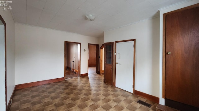 unfurnished bedroom featuring crown molding