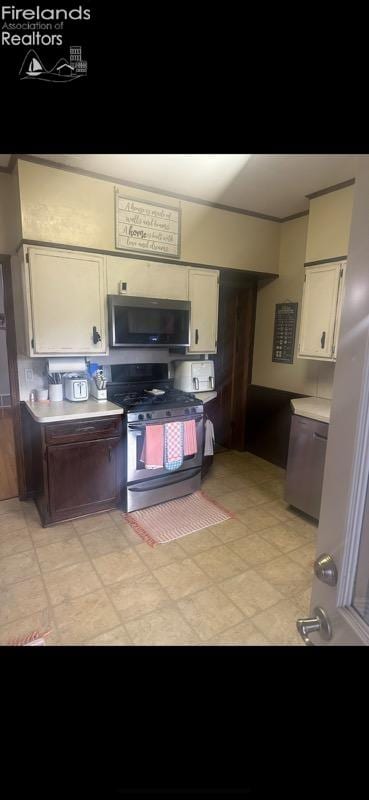 kitchen featuring stainless steel appliances and white cabinetry