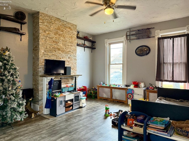 interior space with hardwood / wood-style floors, ceiling fan, and a textured ceiling