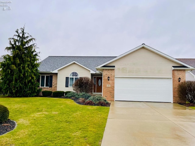 ranch-style home with a garage and a front lawn