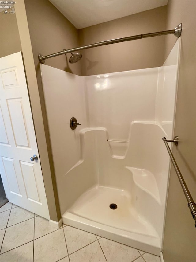 bathroom featuring tile patterned flooring and a shower