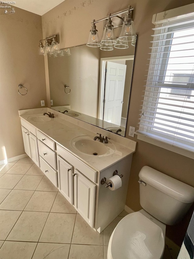 bathroom featuring tile patterned floors, vanity, and toilet