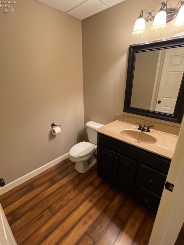 bathroom featuring vanity, toilet, and wood-type flooring