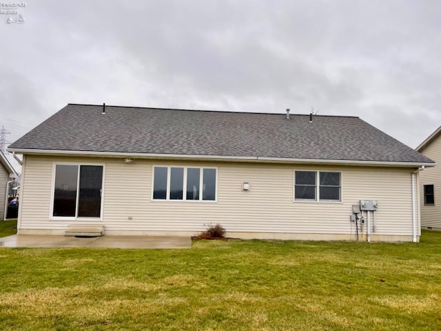 rear view of property featuring a lawn and a patio