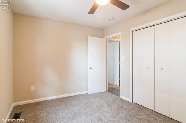 unfurnished bedroom featuring ceiling fan, light carpet, and a closet