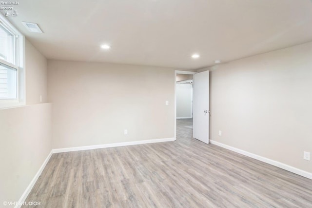 empty room featuring light wood-type flooring and a healthy amount of sunlight