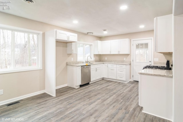 kitchen featuring dishwasher, light wood-type flooring, white cabinetry, and sink