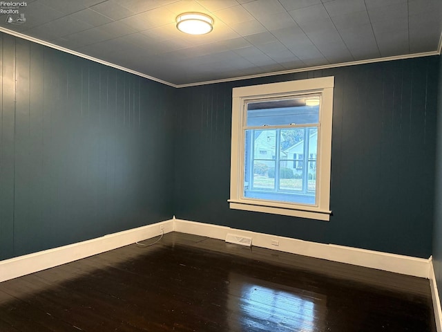 unfurnished room with hardwood / wood-style floors and ornamental molding