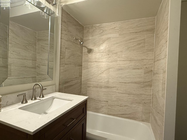 bathroom with vanity and tiled shower / bath combo