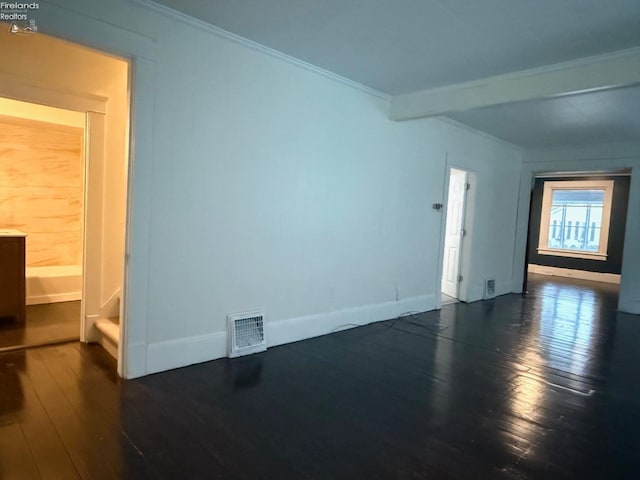 empty room with crown molding and dark wood-type flooring