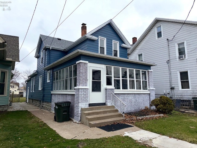 view of front of house with a sunroom