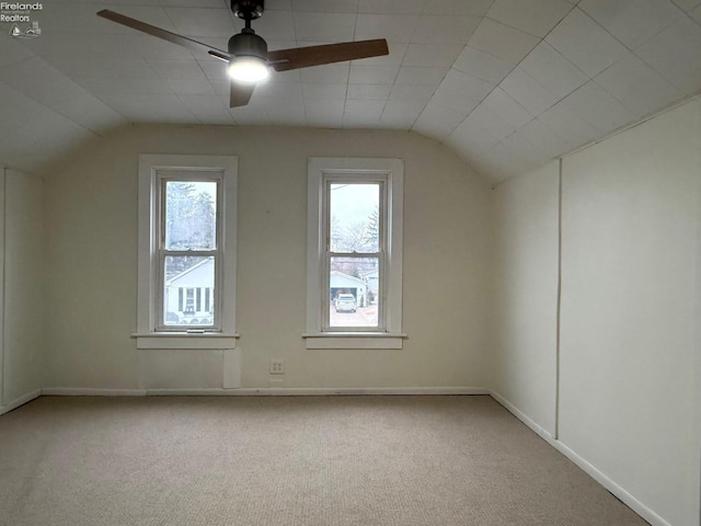 bonus room featuring plenty of natural light, ceiling fan, light colored carpet, and lofted ceiling