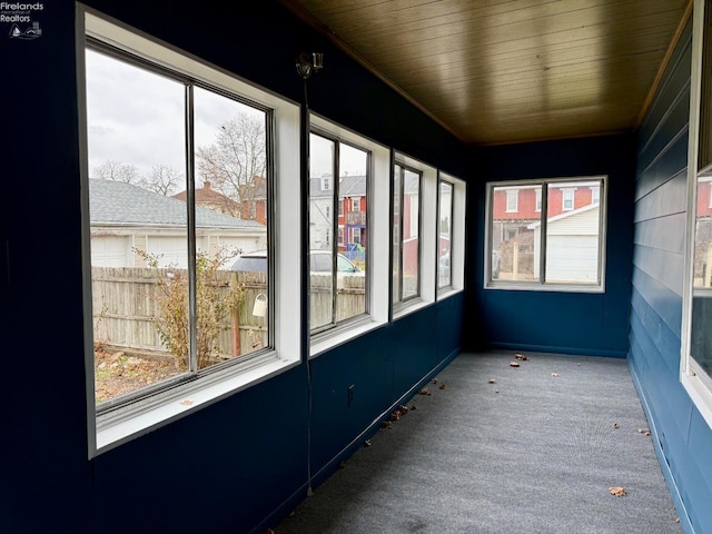 unfurnished sunroom with wood ceiling