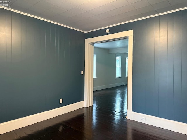 unfurnished room featuring dark hardwood / wood-style floors and ornamental molding