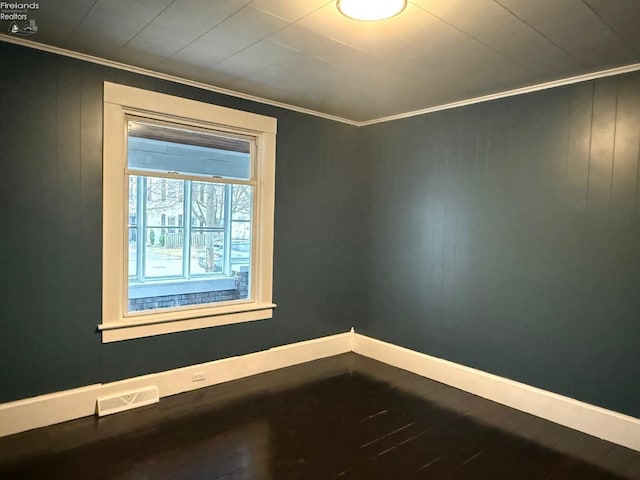 unfurnished room featuring crown molding