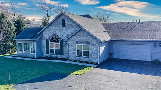 view of front of property featuring a garage and a front yard