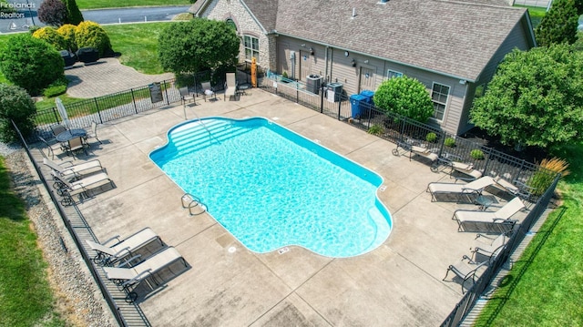 view of pool with a patio area and a yard