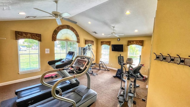 workout area with ceiling fan, lofted ceiling, and a textured ceiling