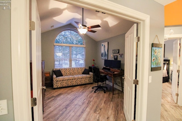 office area featuring ceiling fan, lofted ceiling, and light hardwood / wood-style flooring