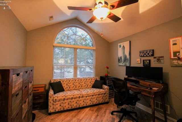 office space featuring ceiling fan, light hardwood / wood-style floors, and lofted ceiling