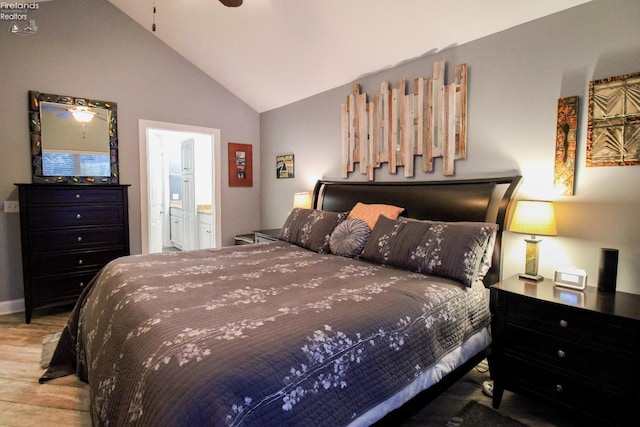 bedroom with vaulted ceiling, light hardwood / wood-style floors, and ensuite bath