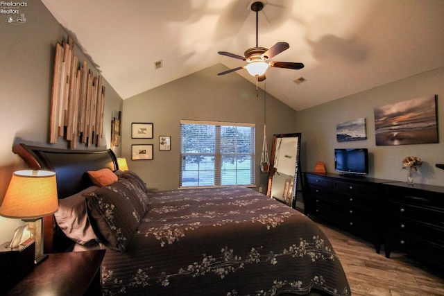 bedroom with light hardwood / wood-style flooring, ceiling fan, and lofted ceiling