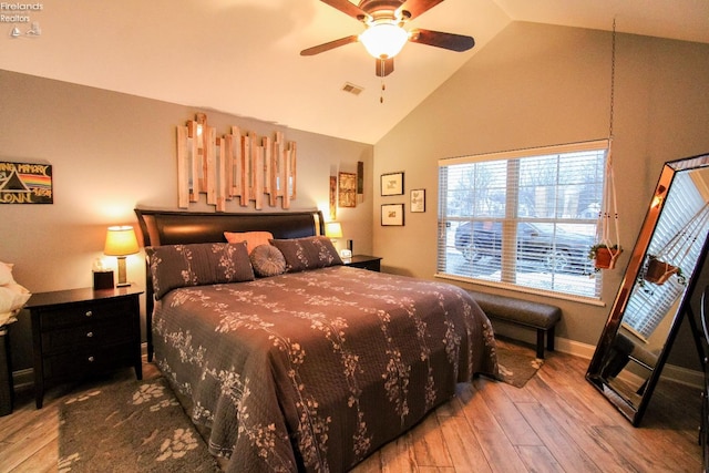 bedroom featuring ceiling fan, wood-type flooring, and lofted ceiling