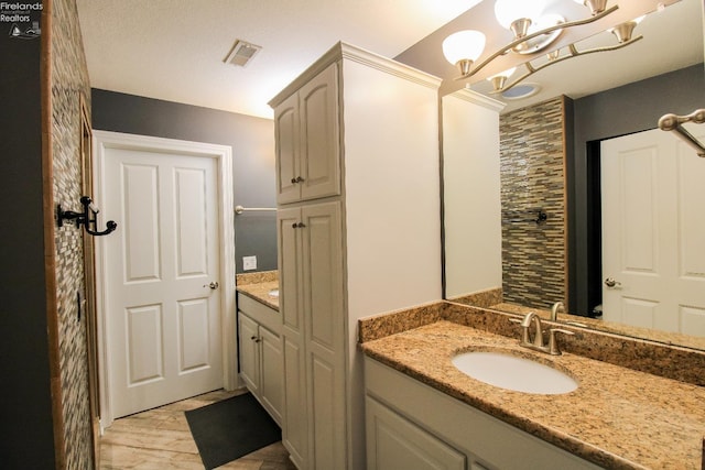 bathroom featuring vanity and an inviting chandelier