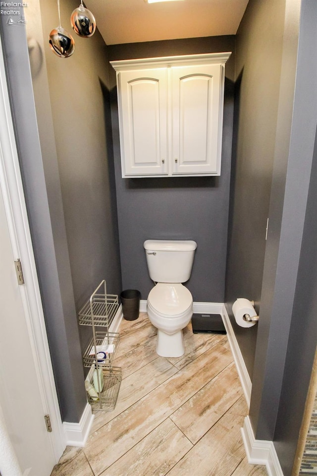 bathroom featuring hardwood / wood-style flooring and toilet