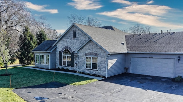 view of front of property with a front lawn and a garage