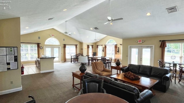 carpeted living room featuring ceiling fan, vaulted ceiling, a textured ceiling, and french doors