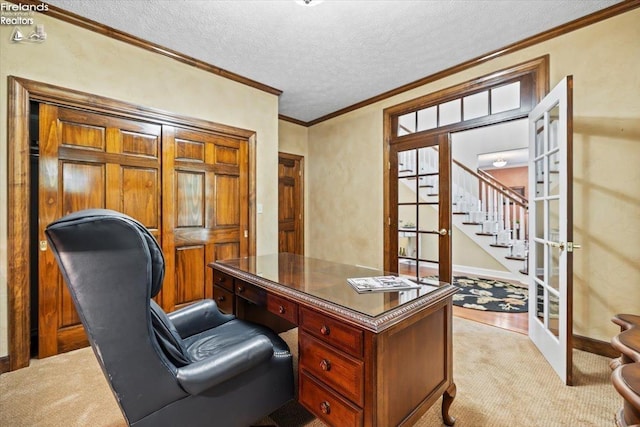 office area featuring a textured ceiling, ornamental molding, light carpet, and french doors