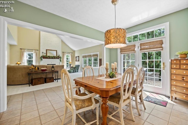 tiled dining room with vaulted ceiling