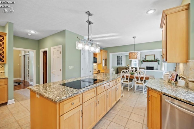 kitchen with light stone counters, black electric cooktop, pendant lighting, dishwasher, and a kitchen island