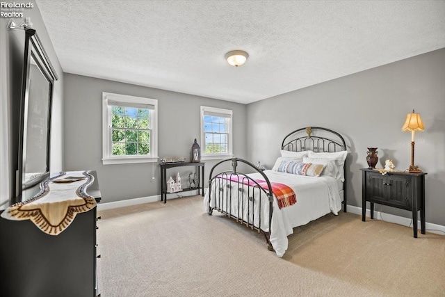 carpeted bedroom with a textured ceiling