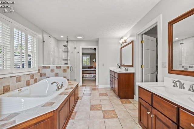 bathroom featuring a textured ceiling, vanity, ceiling fan, tile patterned flooring, and shower with separate bathtub