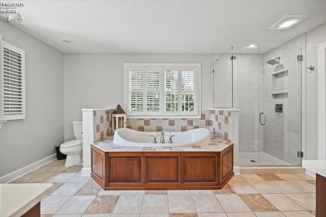 full bathroom with vanity, tile patterned floors, toilet, a textured ceiling, and independent shower and bath