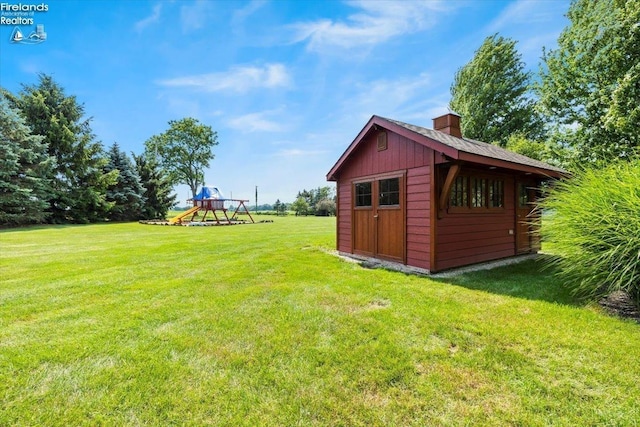 view of yard with a playground and a storage shed