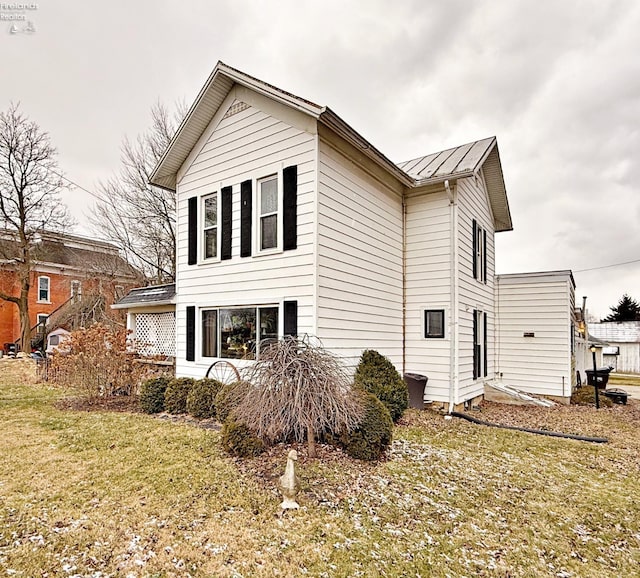 view of property exterior with a yard