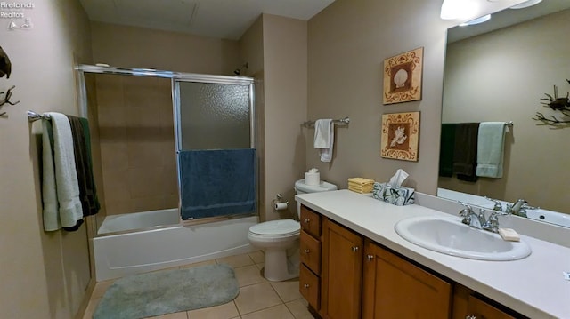 full bathroom with tile patterned flooring, vanity, toilet, and enclosed tub / shower combo