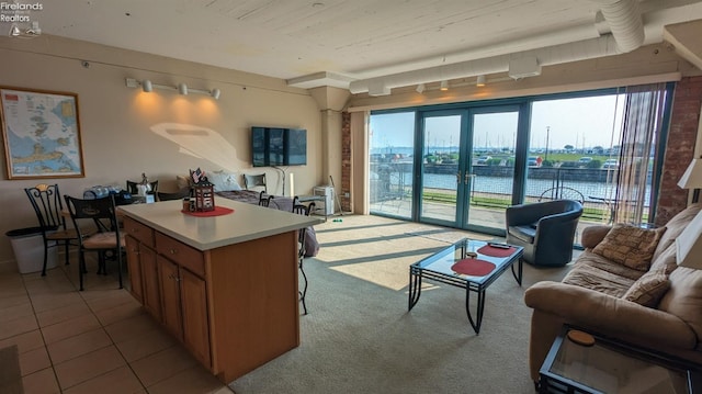 kitchen featuring a kitchen island, light tile patterned flooring, and french doors