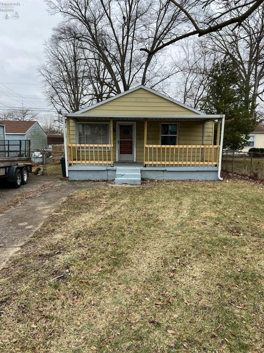 bungalow-style house with a front yard and a porch