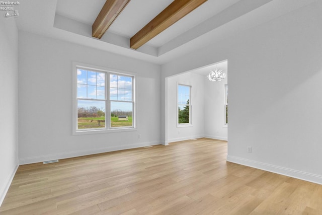 empty room with beamed ceiling, a chandelier, and light wood-type flooring