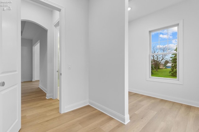 hallway with light hardwood / wood-style flooring