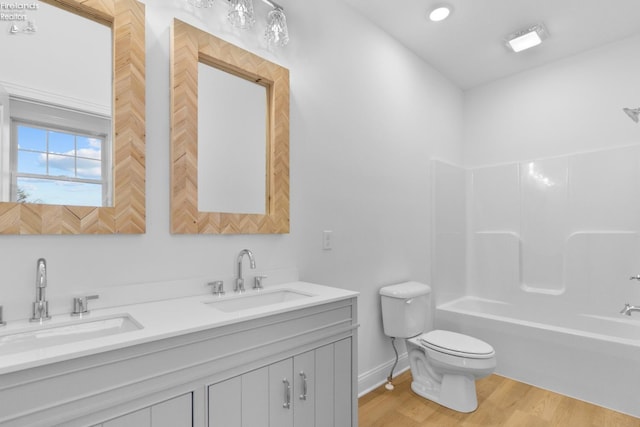 full bathroom featuring shower / tub combination, vanity, hardwood / wood-style flooring, and toilet