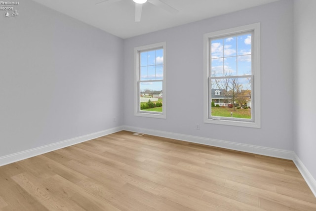 spare room with light hardwood / wood-style floors, plenty of natural light, and ceiling fan